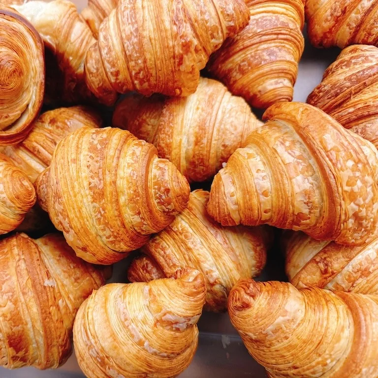 A tray of hand-laminated butter croissants fresh from the oven